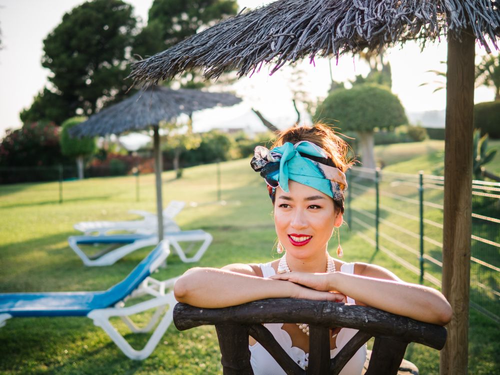 Young elegant Chinese woman sunbathing