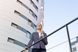 Serious businesswoman leaning on railing