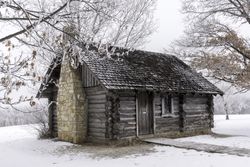 A pine lodge surrounded with frosted branched