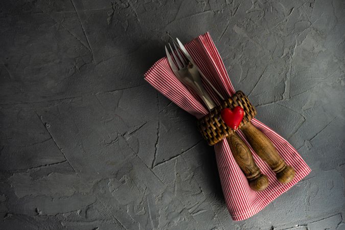 Valentine's day concept with silverware wrapped with napkin ring and heart