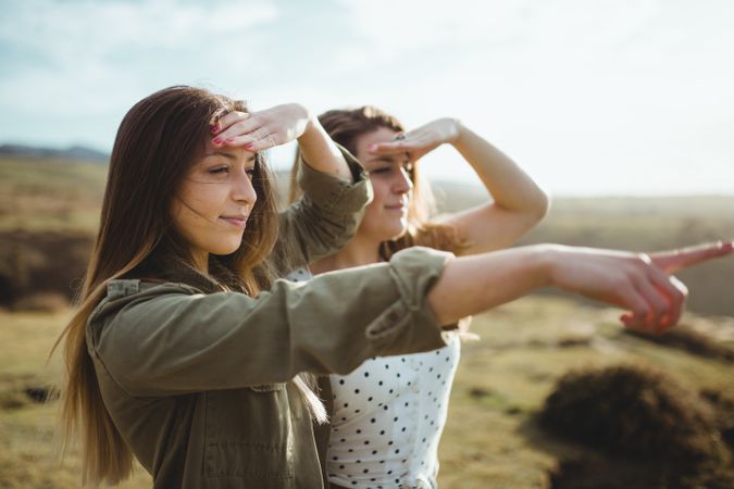 Happy female travelers enjoying freedom at seaside
