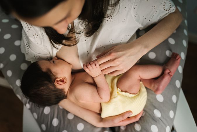Mother feeding baby at home