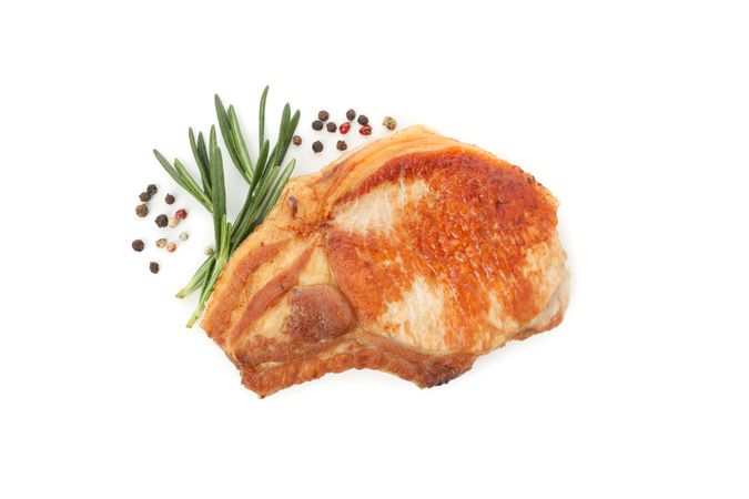 Fried pork steak isolated on light background. Grilled food