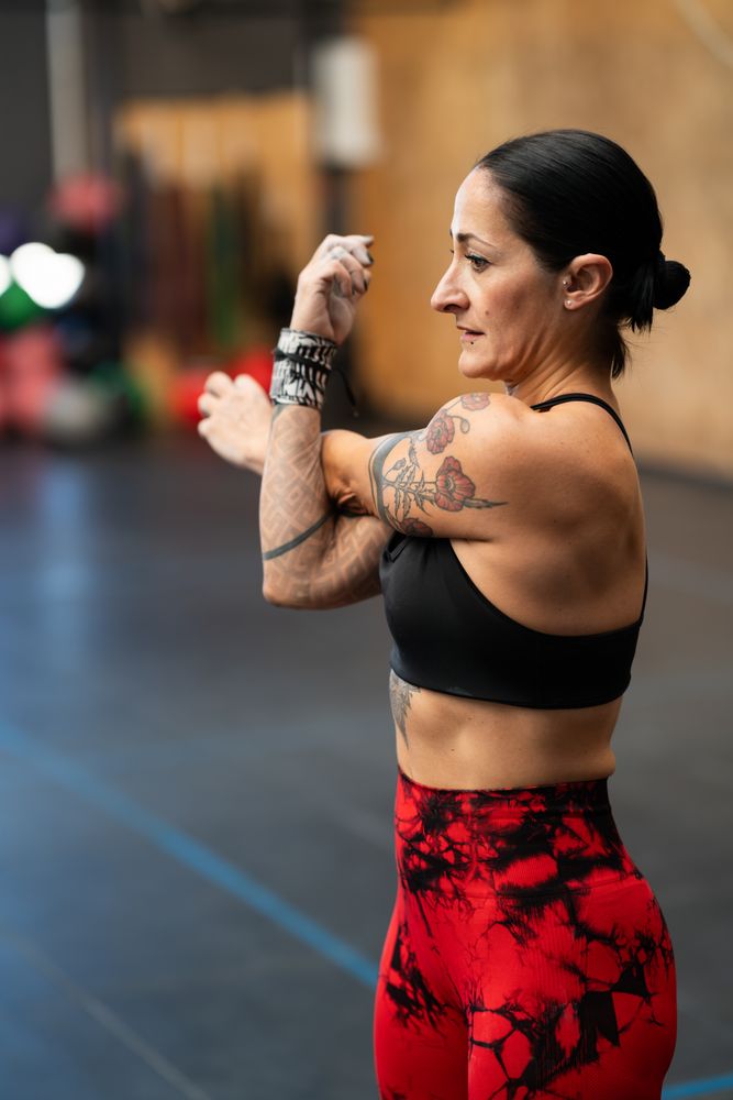 Fit woman warming up arms by stretching