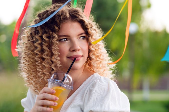 Woman with drink outdoors