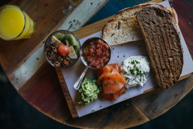 Top view of breakfast plate with lox and fruit