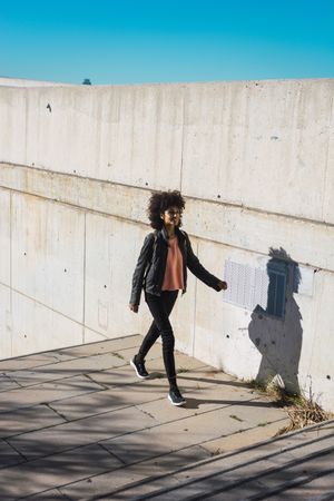 Black woman walking down the street.