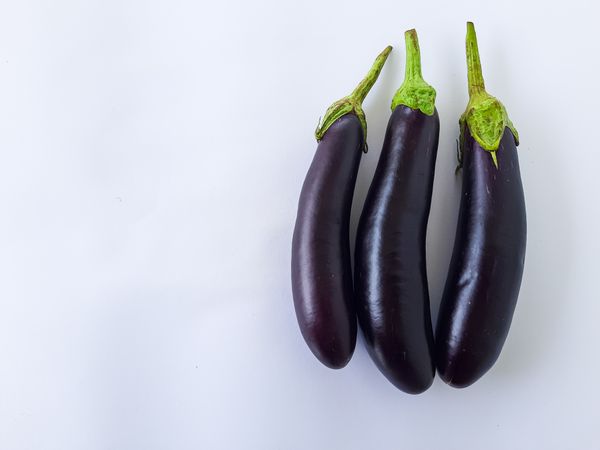 Fresh Eggplants on Plain Background