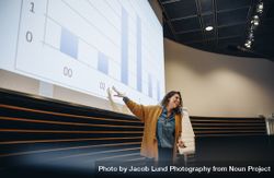 Female speaker giving presentation in conference 0LDyP0