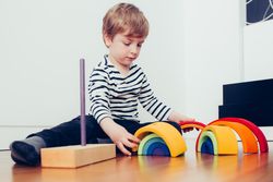 Boy playing with toys on floor