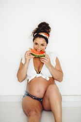 Pregnant female eating delicious watermelon
