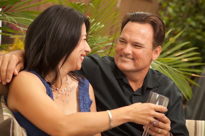Smiling Interracial Couple Drinking Wine