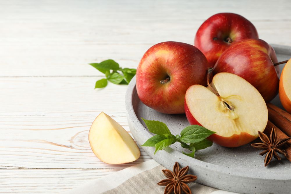 Plate of apples, anise and cinnamon sticks with copy space