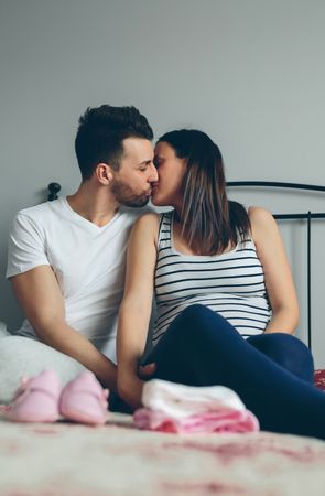 Man kissing his pregnant wife