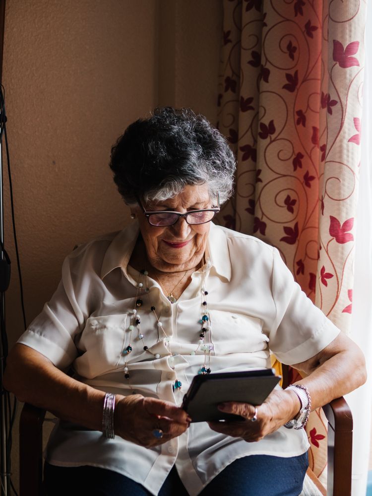 Mature female reading e-book at home