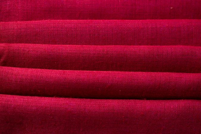 Close up Red fabric folded background texture.