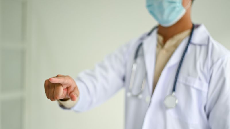 Cropped shot of A doctor in a lab uniform pointing to the front