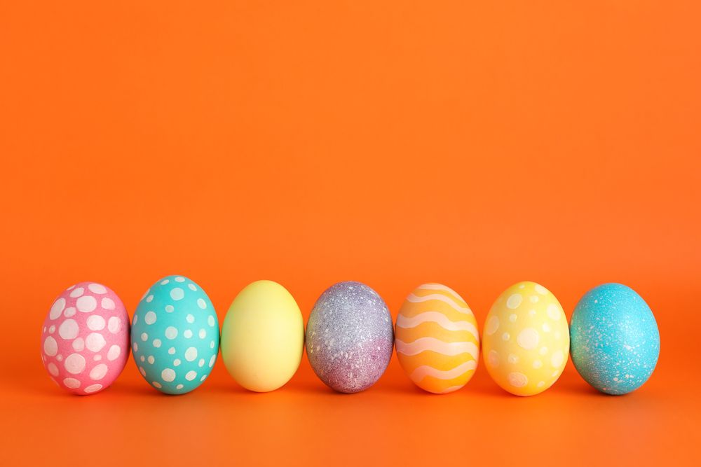 Decorated Easter eggs on color background. Space for text