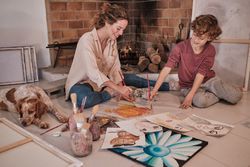 Woman and boy having fun and painting together