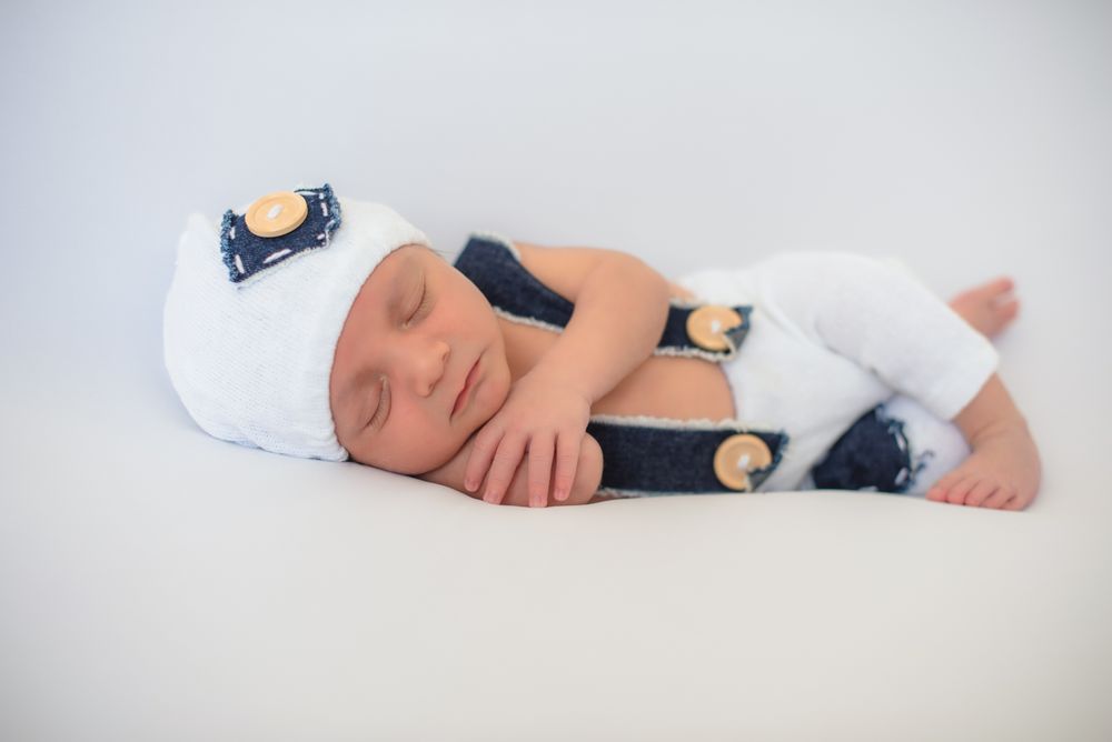 Cute infant sleeping on bed
