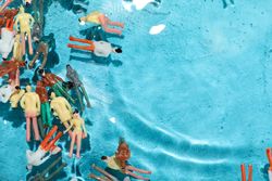 Toy people lying in water