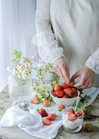 Confectioner cooking dessert of ripe strawberries