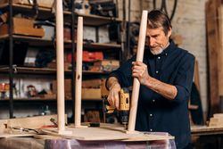 Man using powertools on table