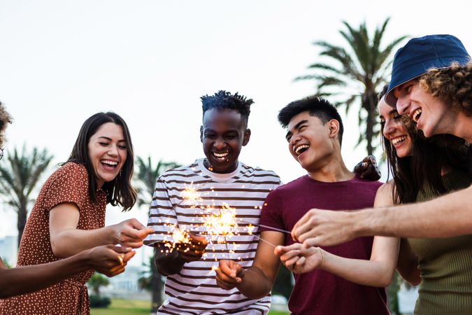 Happy multiracial people enjoying summer party at the beach