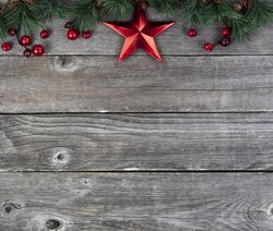 Red star with fir branches on old wooden planks