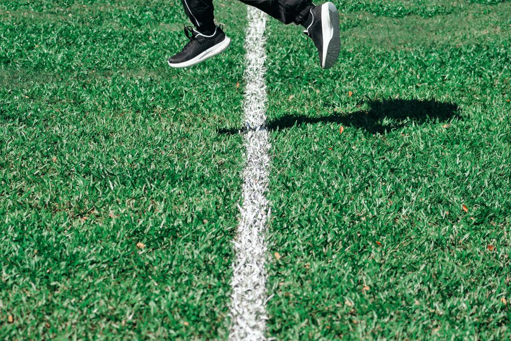Person jumping over field line