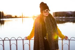 Charming woman in casual wear on shore of lake