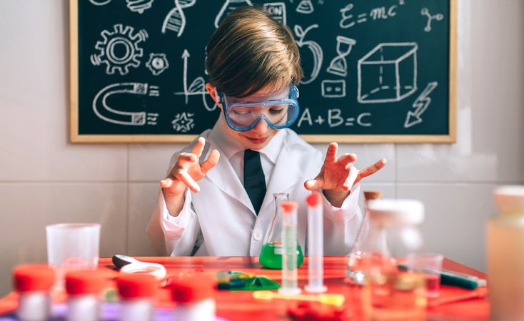 Boy playing with toy chemistry game