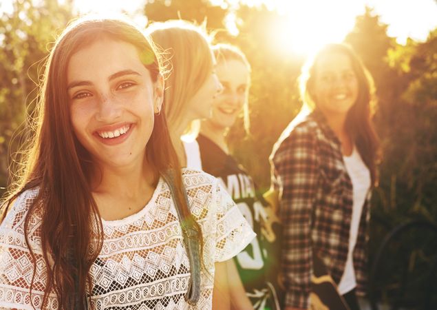 Group of female friends smiling in the sun