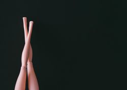 Doll legs on dark background