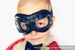Close up of blond boy wearing airplane goggles bGrNa4