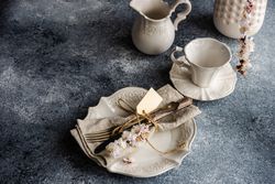 Spring floral concept with apricot blossom in modern vase on grey room