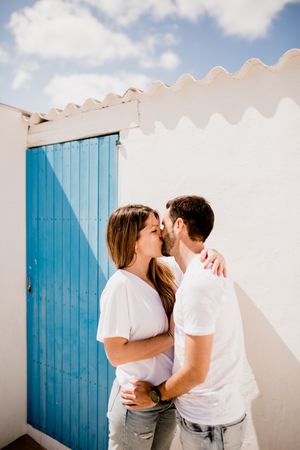 Loving couple cuddling near beach house