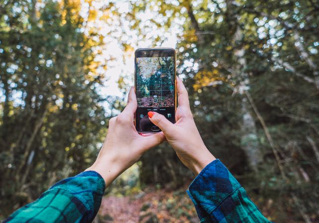 Casual tourist making photo on smartphone of nature