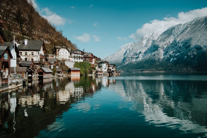 Mountain coast with houses along turquoise lake