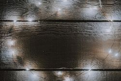 Christmas tree lights decoration on bright wooden background