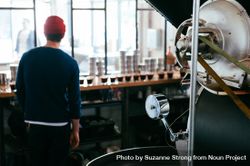 Back view of coffee roaster master looking into coffee shop with glasses for tasting 5Xrd7b