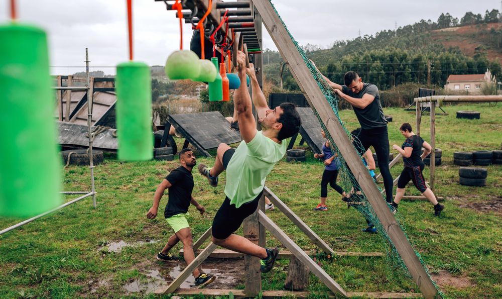 Participant obstacle course doing suspension