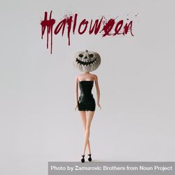 Doll in dress with skull pumpkin head with “Halloween” text 41jZZb