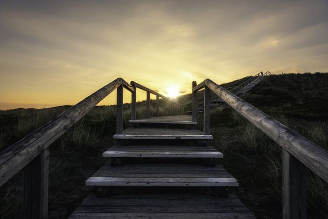 Climbing wooden stairs on Sylt island dunes