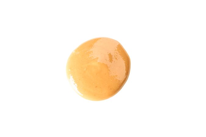 Creamy peanut butter isolated on light background, top view. A traditional product of American cuisine
