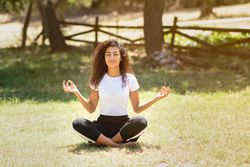 Arab woman doing yoga in nature