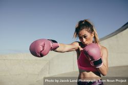 Sportswoman training boxing outdoors 0Ld37r