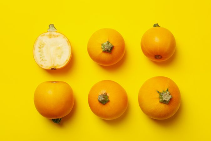 Round zucchini on yellow background, top view