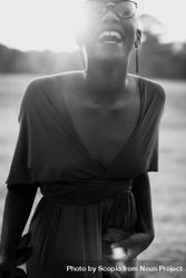 Woman wearing v neck dress laughing in grayscale 5qBla4
