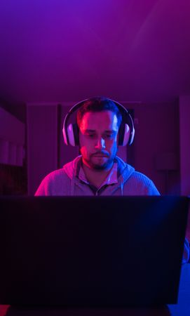 Man listening cheerfully to music with headphones.